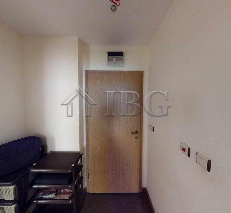 Interior view of a one-bedroom apartment in Avalon, Sunny Beach, showing minimal decor and entry doo.