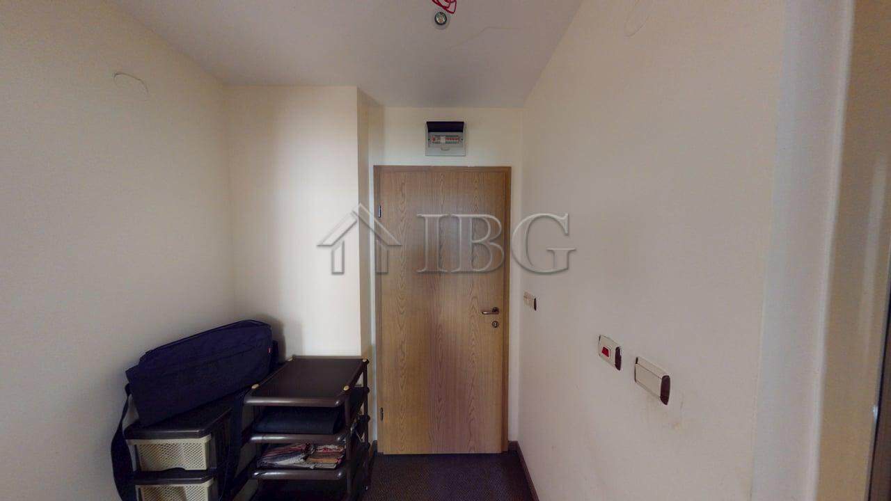 Interior view of a one-bedroom apartment in Avalon, Sunny Beach, showing minimal decor and entry doo.