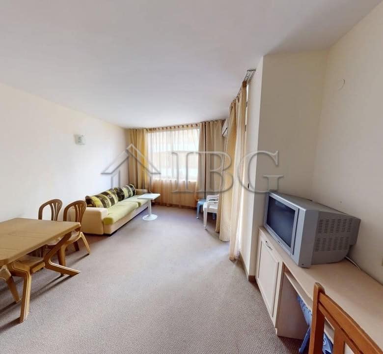 Bright living room of a one-bedroom apartment in Avalon, Sunny Beach, with modern furniture and larg.
