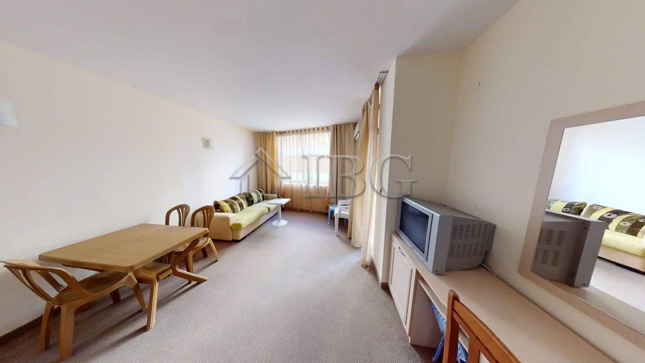 Bright living room of a one-bedroom apartment in Avalon, Sunny Beach, with modern furniture and larg.