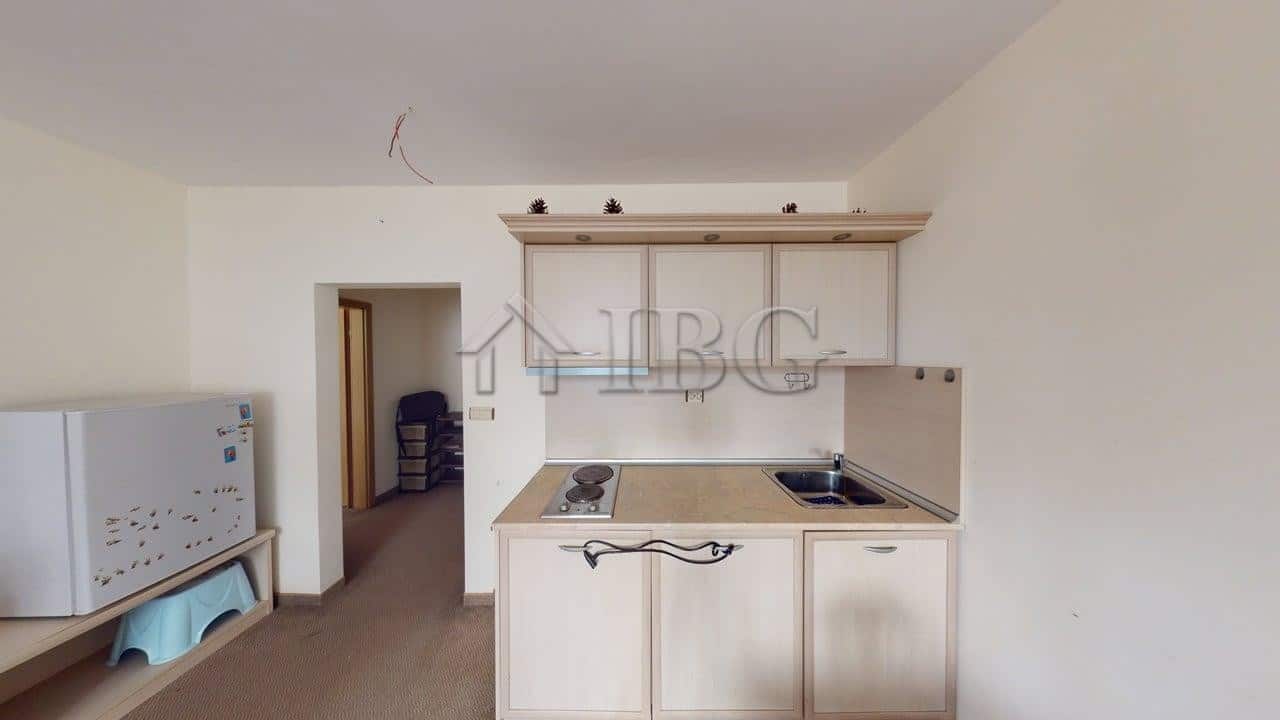 Compact kitchen in Avalon, Sunny Beach apartment with basic appliances and light-colored cabinets.