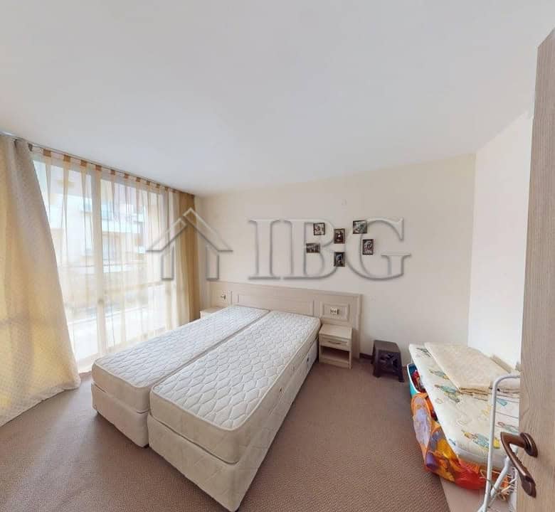Bright bedroom in Avalon apartment with large window and cozy decor in Sunny Beach.