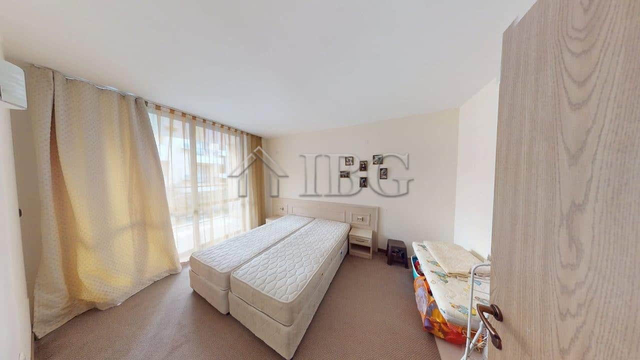 Bright bedroom in Avalon apartment with large window and cozy decor in Sunny Beach.