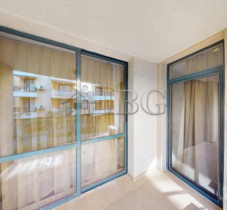 Balcony view of a one-bedroom apartment in Avalon, Sunny Beach, with glass sliding doors and outdoor.
