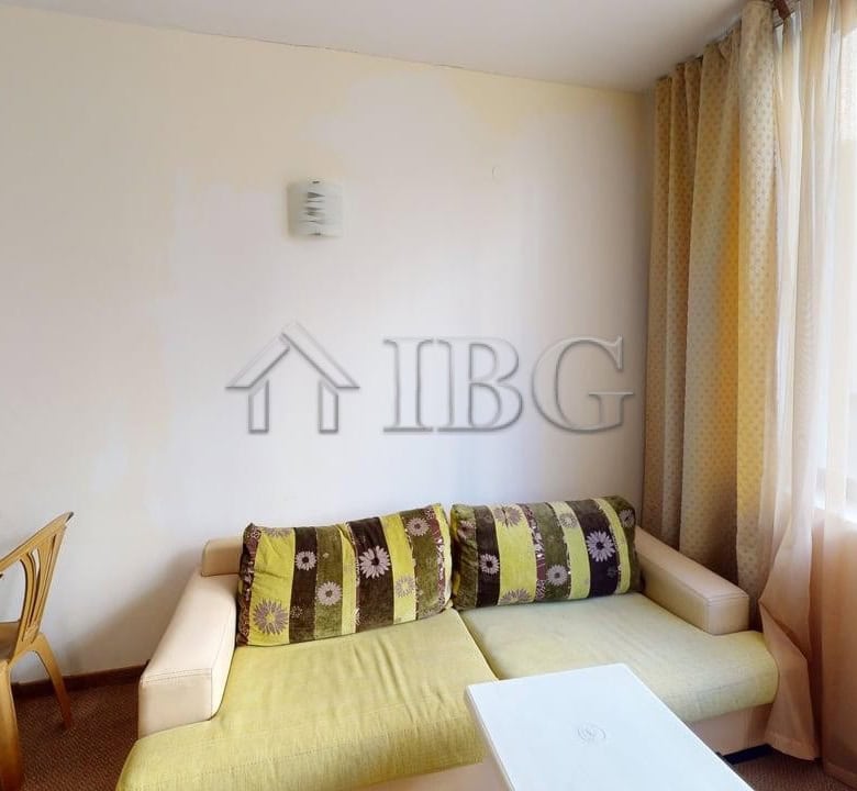 Bright living room in Avalon apartment with large windows and modern decor.