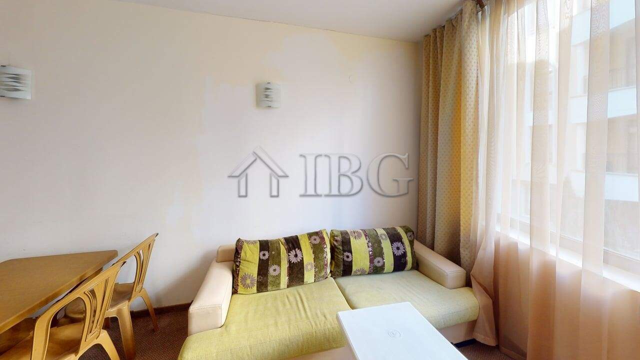 Bright living room in Avalon apartment with large windows and modern decor.