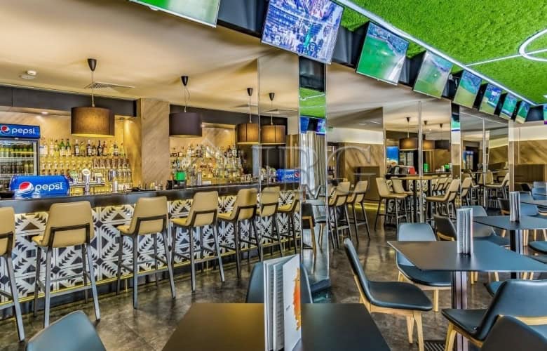 Modern bar with seating and TV screens at Barceló Royal Beach, Sunny Beach.