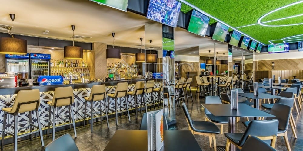 Modern bar with seating and TV screens at Barceló Royal Beach, Sunny Beach.