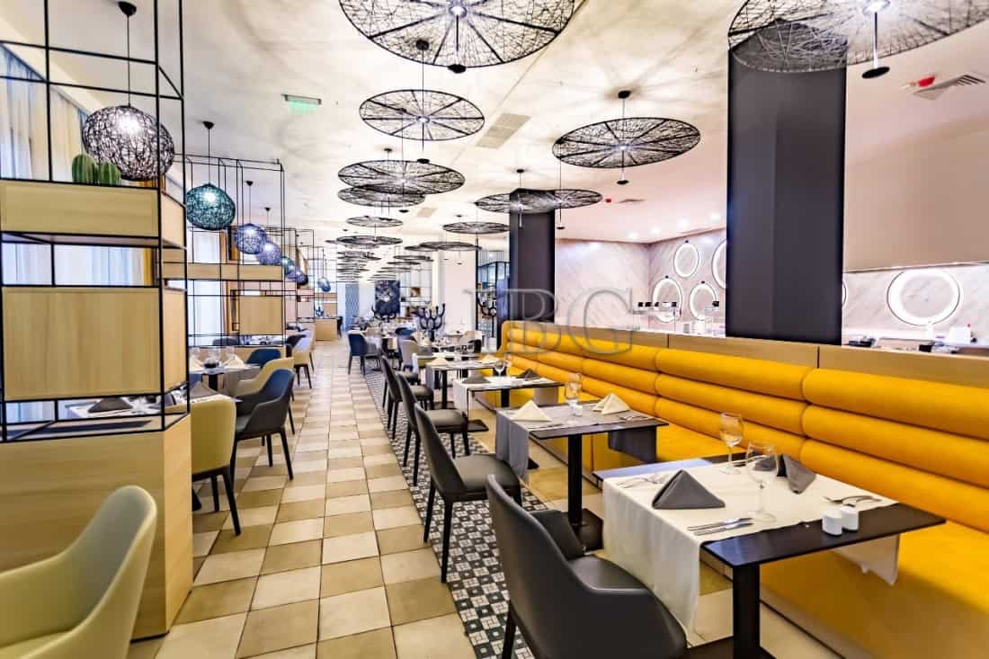 Modern restaurant interior with stylish decor and seating options Elegant restaurant dining area with contemporary design and cozy ambiance.