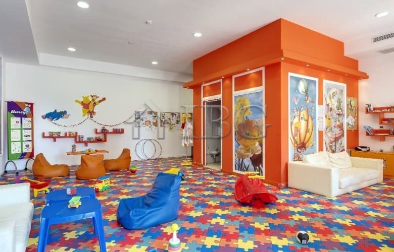 Bright indoor play area with colorful furniture and sea-themed decor.