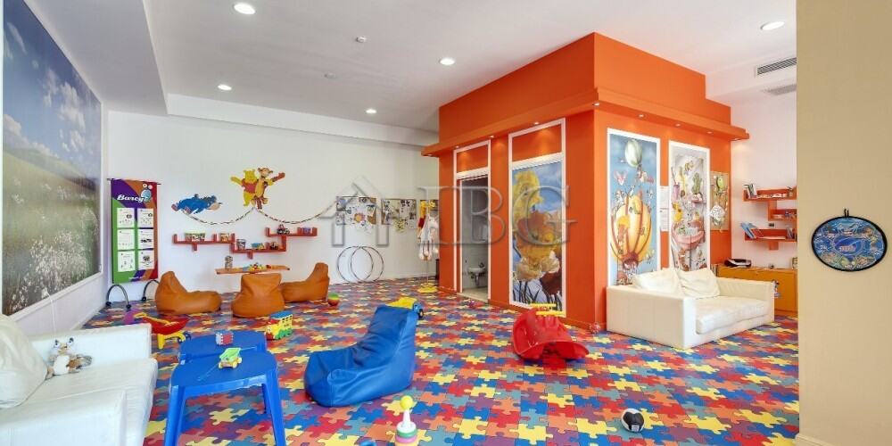 Bright indoor play area with colorful furniture and sea-themed decor.