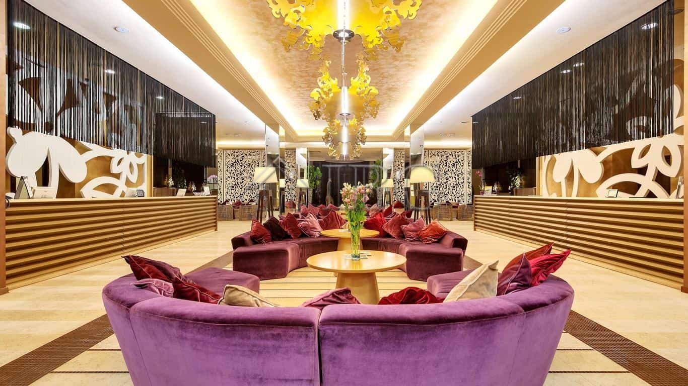Luxurious Hotel Lobby with Elegant Decor Elegant hotel lobby featuring plush purple seating and modern design elements.