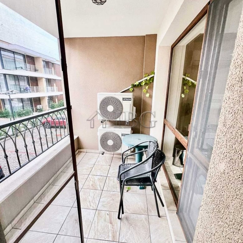 Bright balcony with sea view and outdoor seating in Burgas Beach Resort.