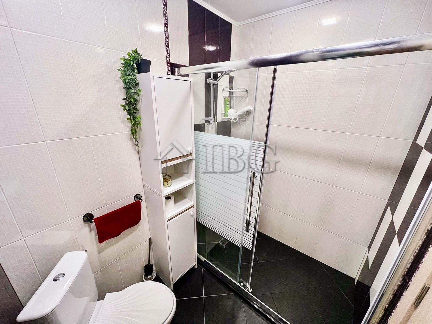 Bright bathroom with shower enclosure and modern fixtures in Burgas Beach Resort.