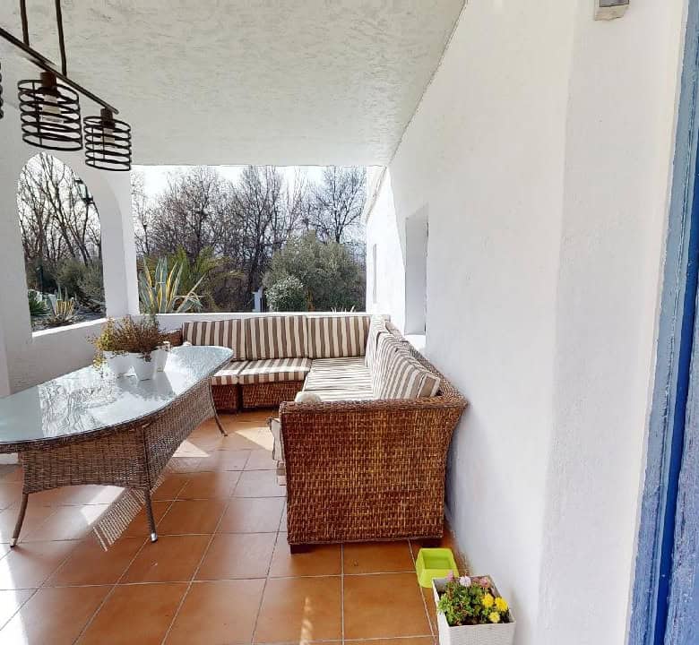 Boutique hotel terrace in Caniles, Granada, Spain, with outdoor seating and scenic views.