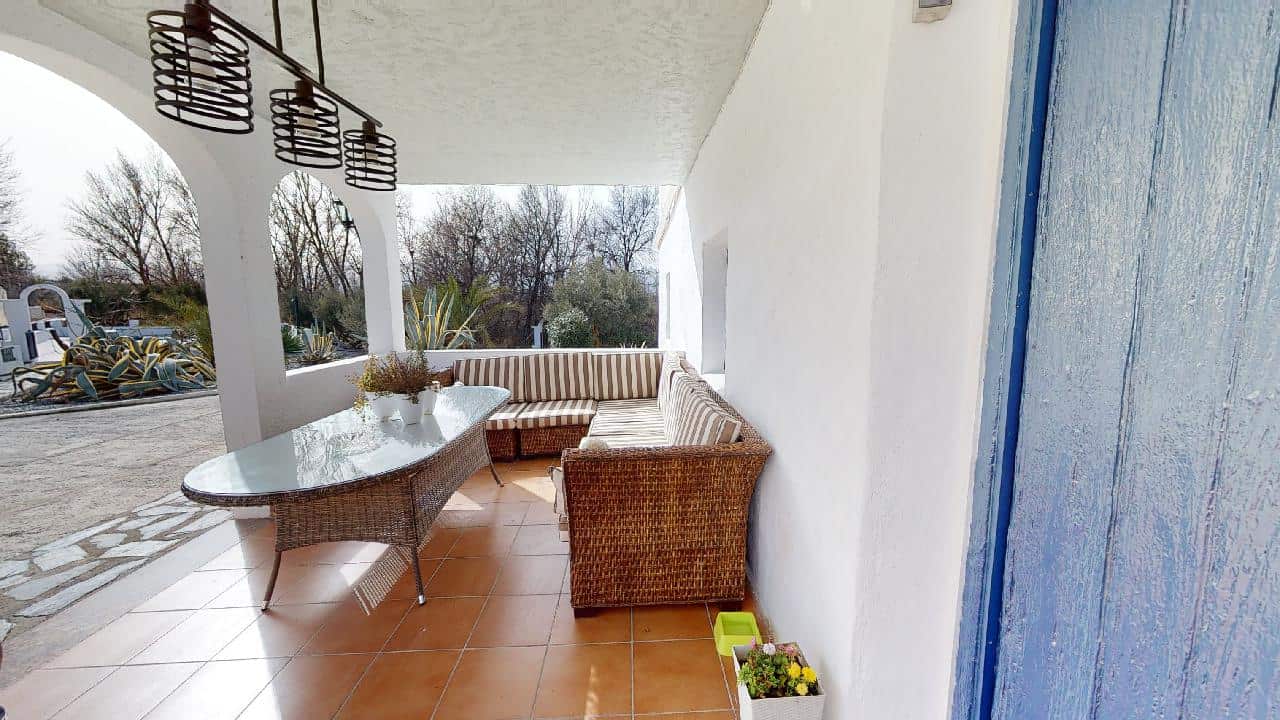 Boutique hotel terrace in Caniles, Granada, Spain, with outdoor seating and scenic views.