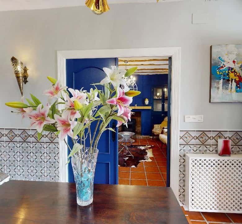 Charming boutique hotel interior with elegant decor and vibrant flowers in Caniles, Granada, Spain.