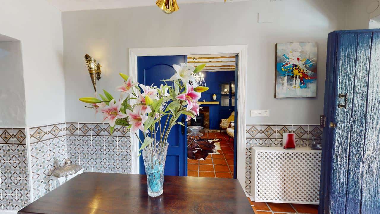 Charming boutique hotel interior with elegant decor and vibrant flowers in Caniles, Granada, Spain.