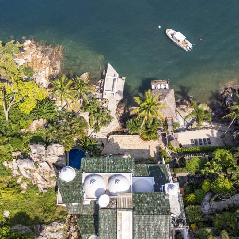 Luxury waterfront villa with lush tropical gardens and private dock.