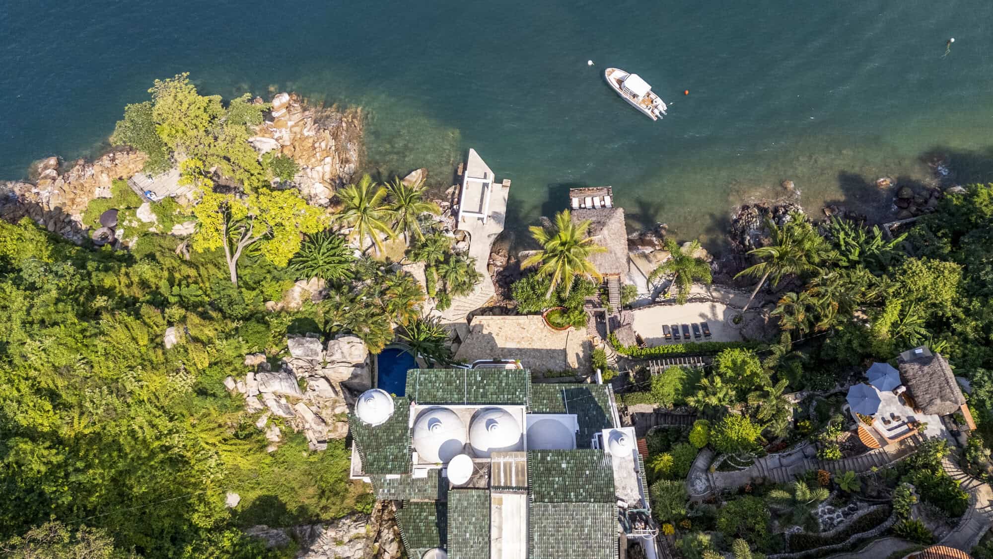 Luxury waterfront villa with lush tropical gardens and private dock.
