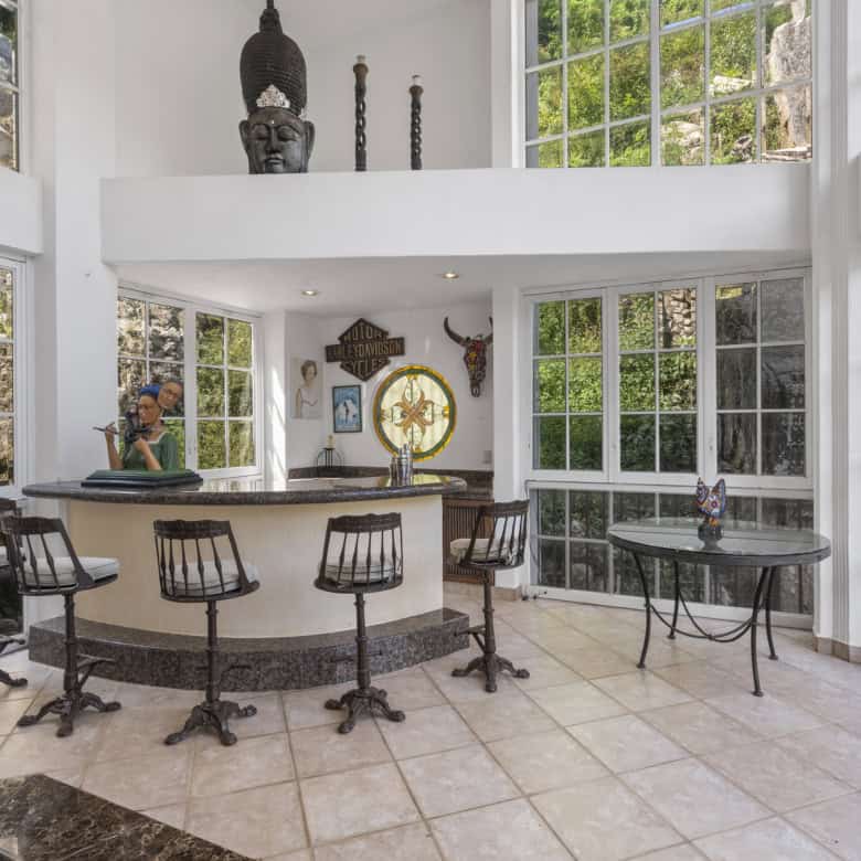 Modern living room featuring expansive windows and stylish decor elements.