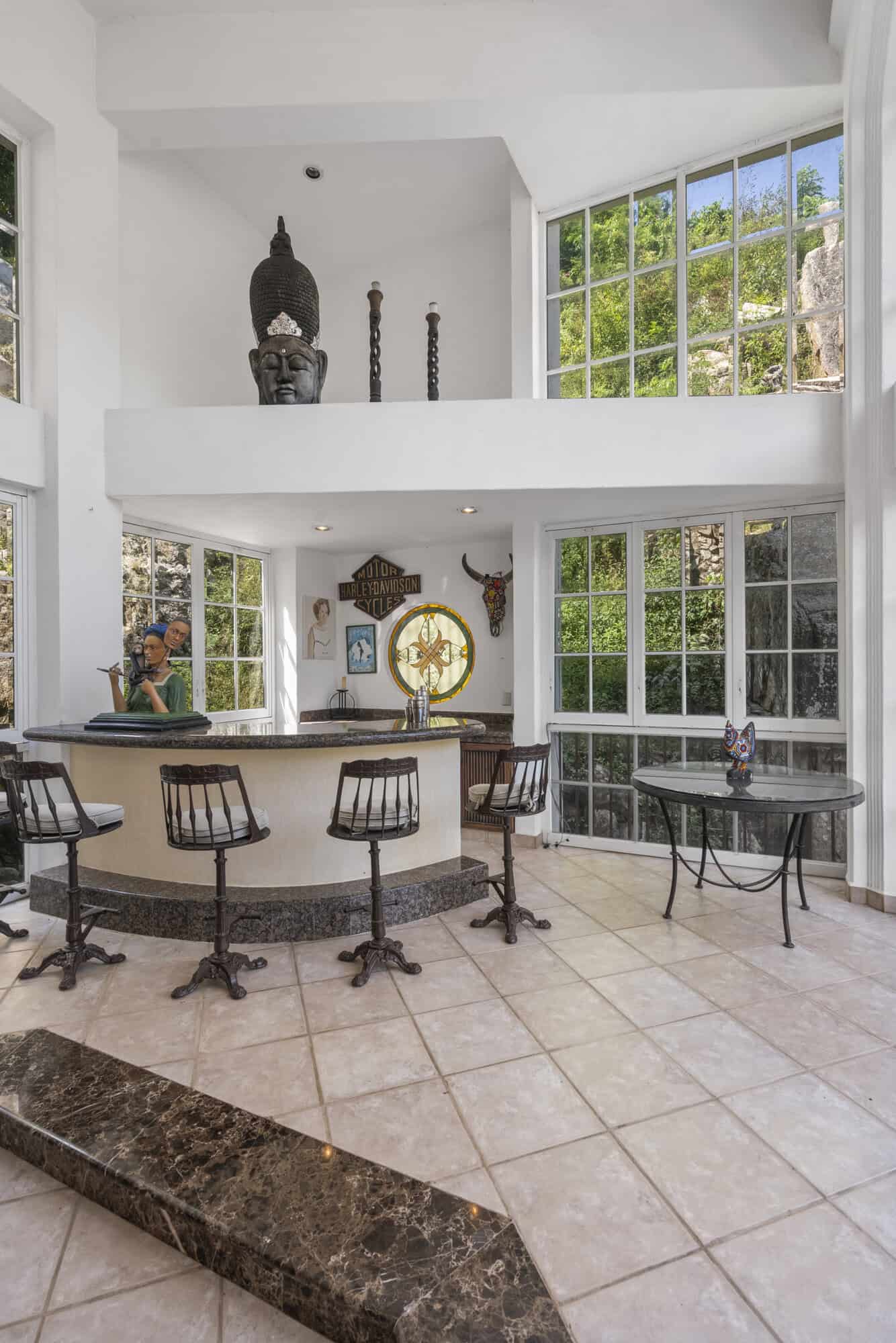Modern living room featuring expansive windows and stylish decor elements.