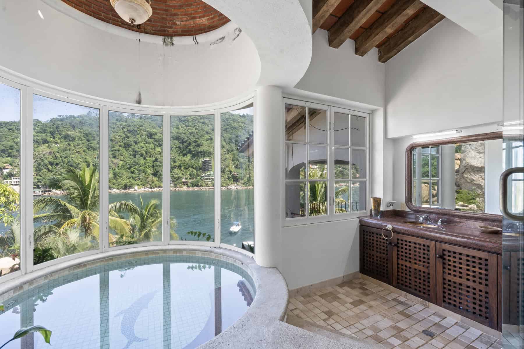 Luxury lakeside villa with pool and panoramic views.