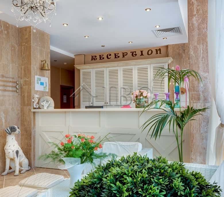 Bright reception area with floral decor and reception desk at Dawn Park, Sunny Beach.