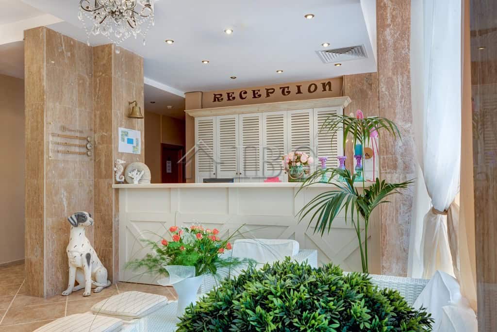 Bright reception area with floral decor and reception desk at Dawn Park, Sunny Beach.