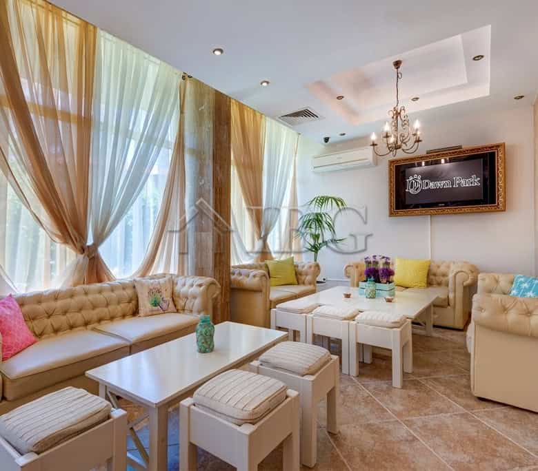 Spacious living room in Dawn Park, Sunny Beach with elegant sofas and large windows.