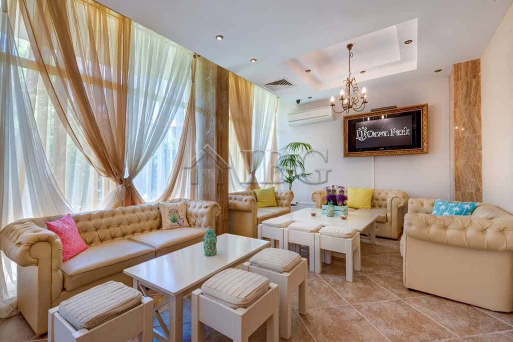 Spacious living room in Dawn Park, Sunny Beach with elegant sofas and large windows.