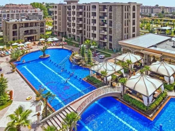 Resort pool with sun loungers and umbrellas at Cascadas Family Resort, Sunny Beach, Bulgaria.