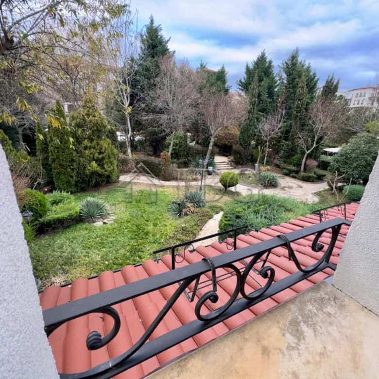 Bright balcony view of lush garden and trees in Nessebar.