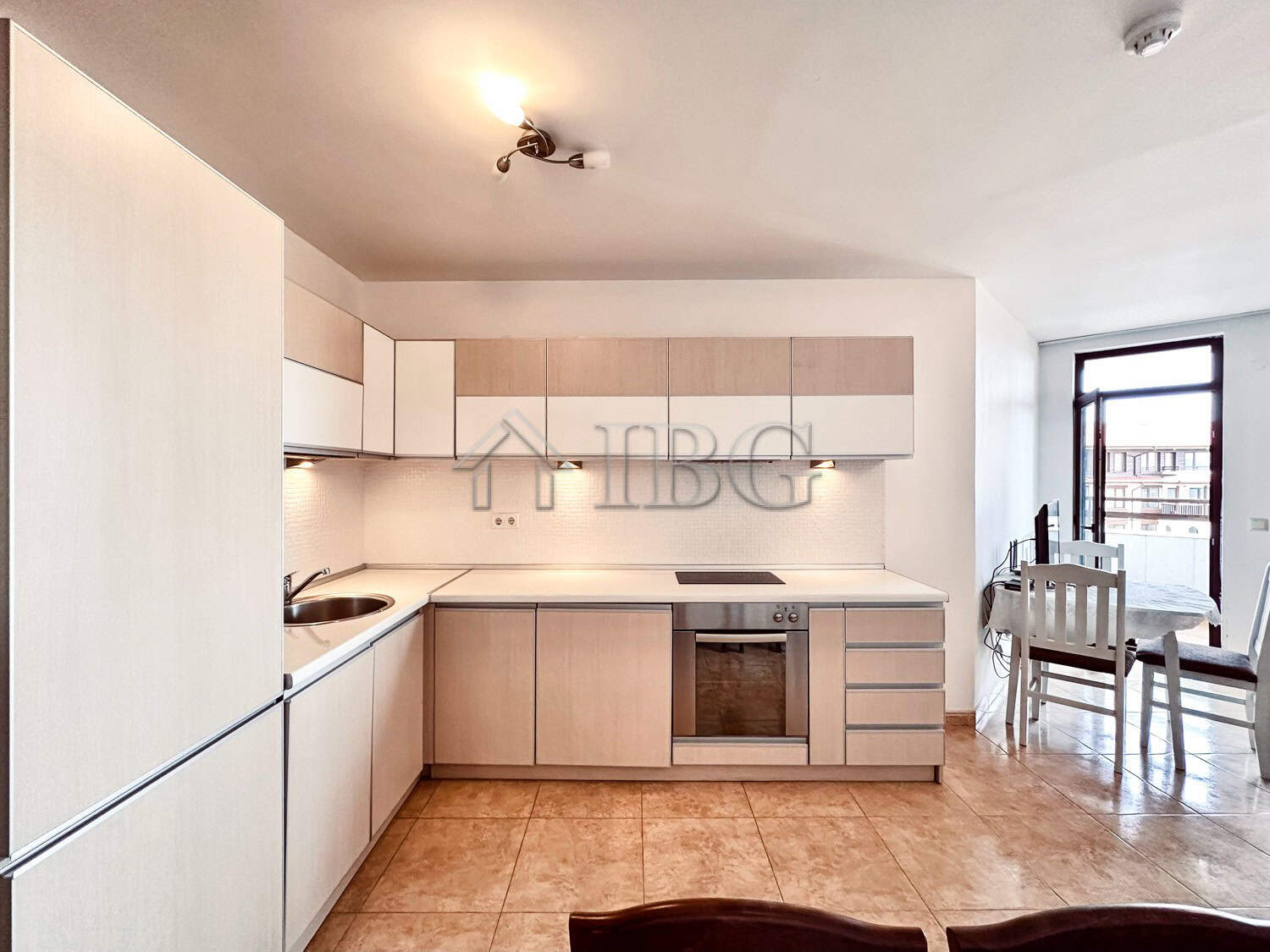 Bright, modern kitchen in a 2-bedroom apartment with sea and pool views.