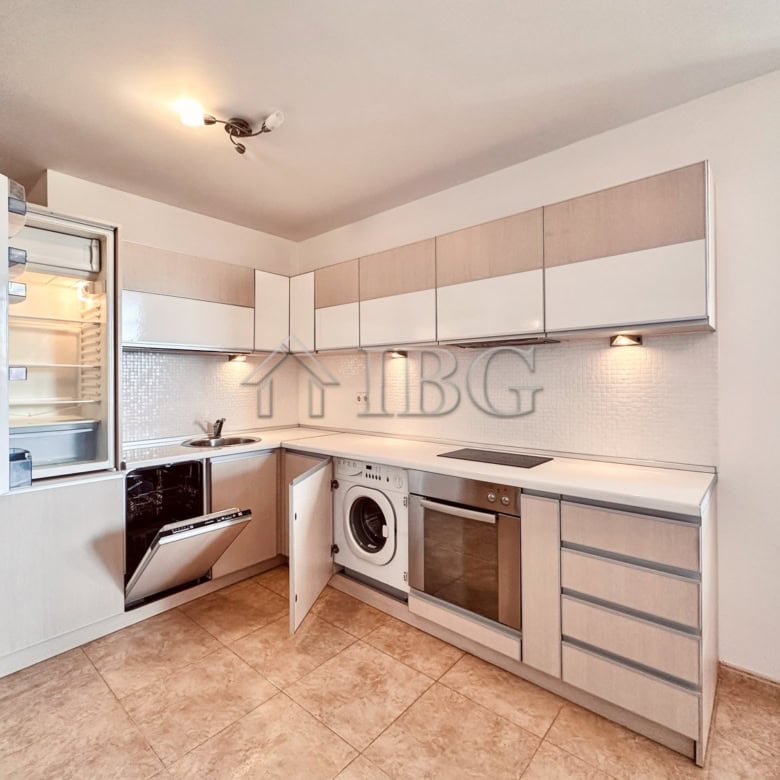 Spacious kitchen in a 2-bedroom apartment featuring sea and pool views, equipped with modern applian.