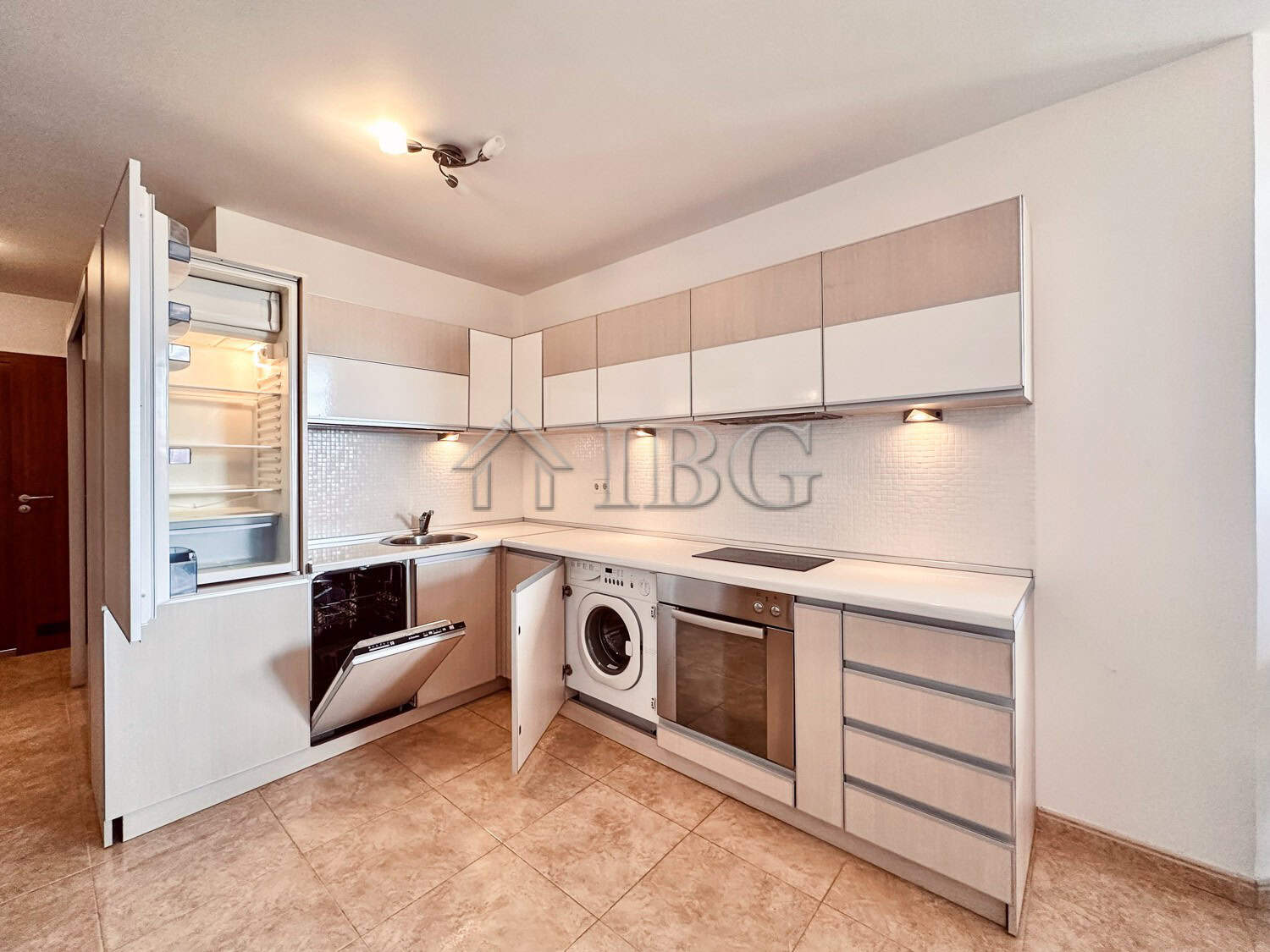 Spacious kitchen in a 2-bedroom apartment featuring sea and pool views, equipped with modern applian.