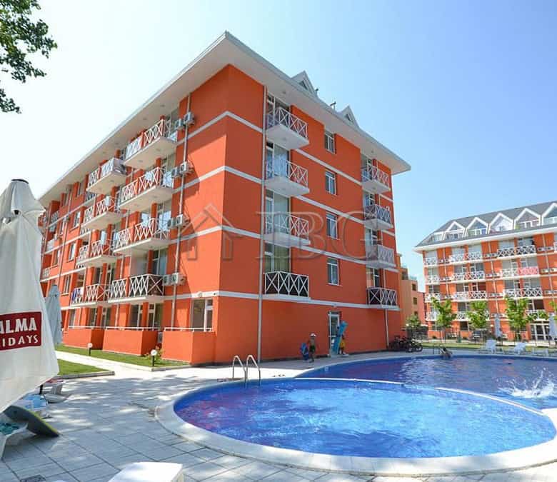 Bright orange duplex apartment building with a swimming pool at Gerber Residence 3, Sunny Beach.
