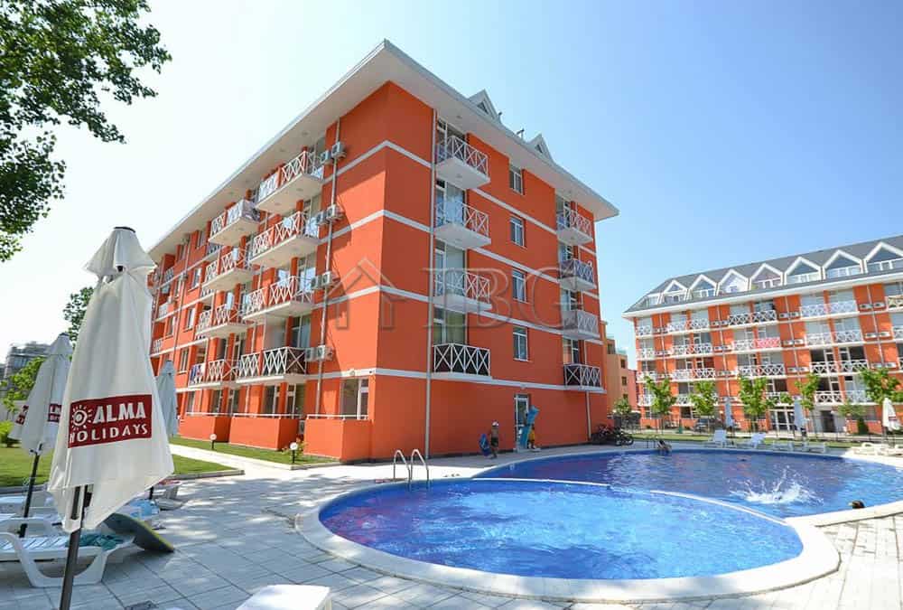Bright orange duplex apartment building with a swimming pool at Gerber Residence 3, Sunny Beach.