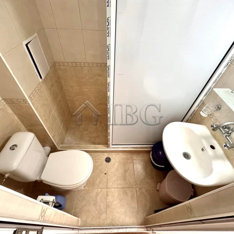 Cozy studio bathroom with shower and balcony access in Sunny Beach.
