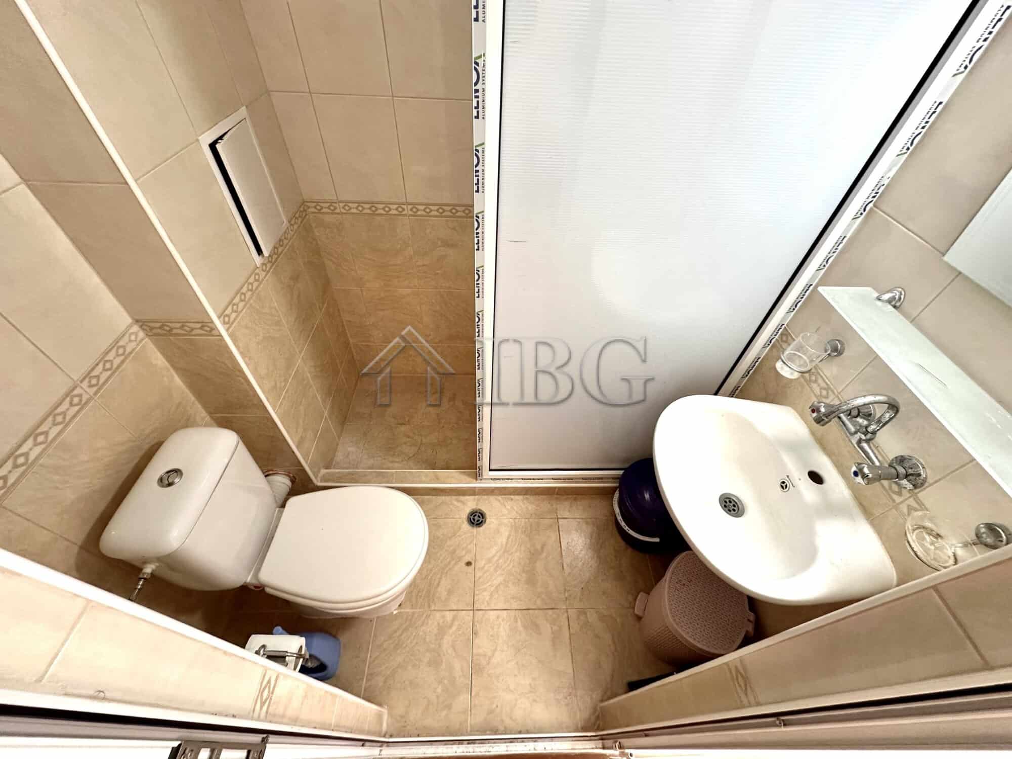 Cozy studio bathroom with shower and balcony access in Sunny Beach.