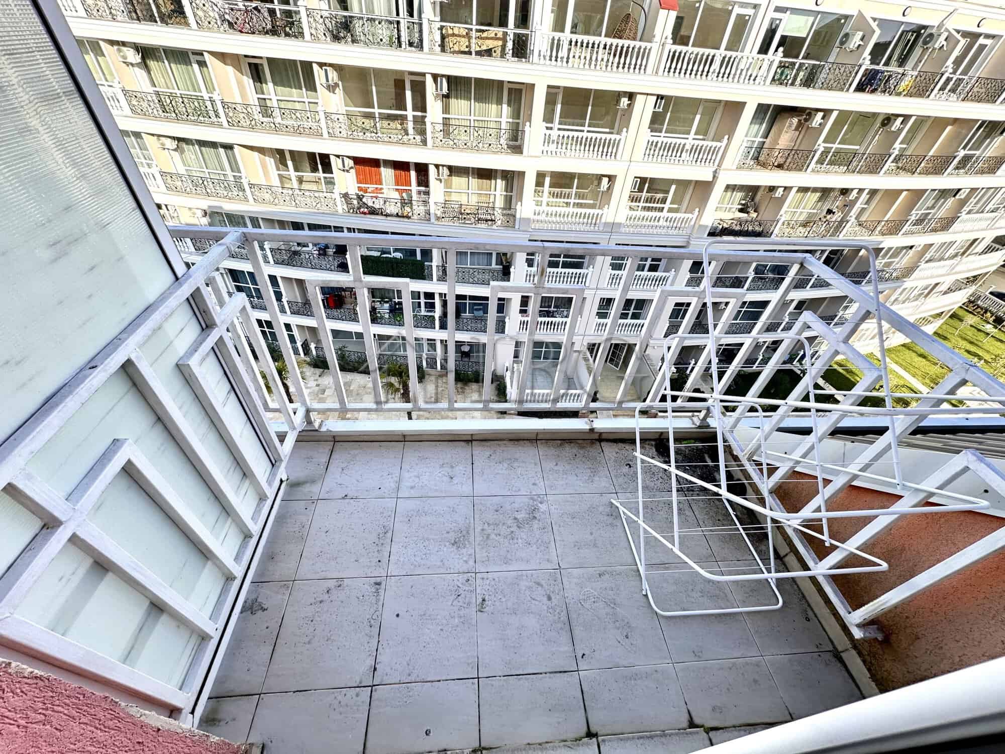 Balcony view of a modern apartment in Gerber 4, Sunny Beach, overlooking neighboring buildings.