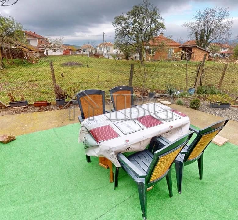 Two-storey house with outdoor patio in a gated community in Poroy Village.