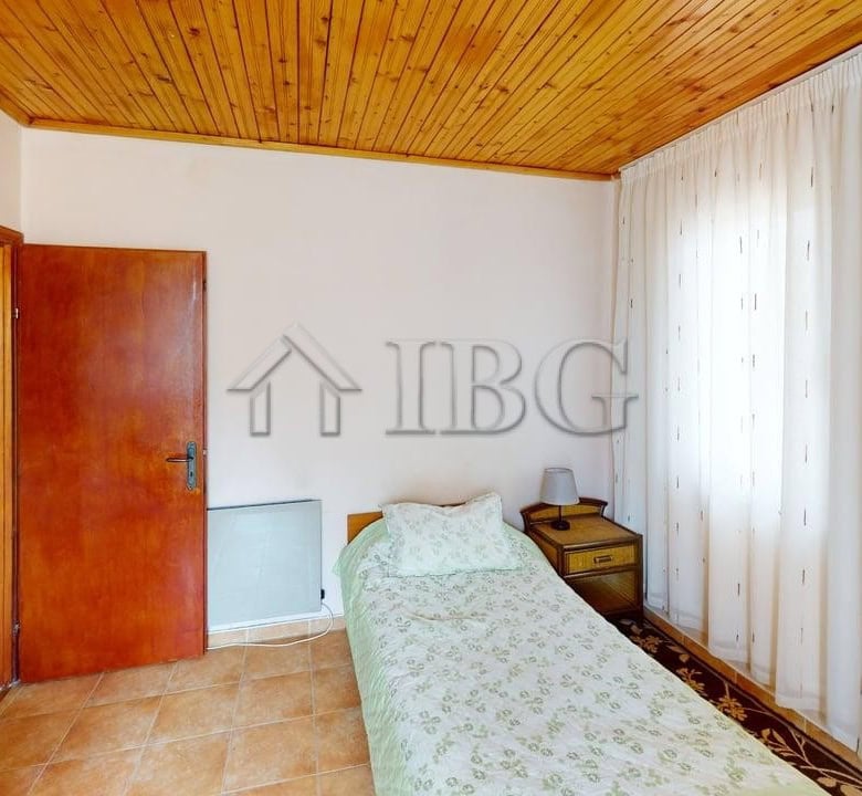 Interior of a cozy two-storey house in a gated complex in Poroy Village, featuring a simple bedroom.