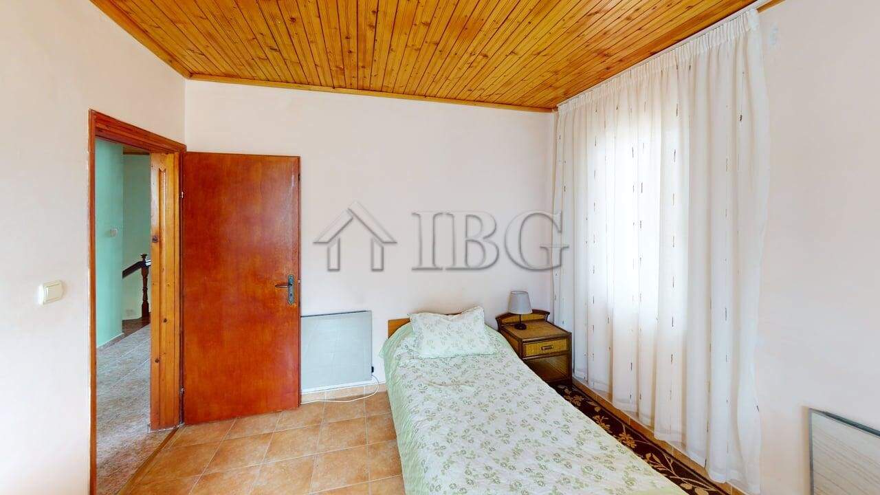 Interior of a cozy two-storey house in a gated complex in Poroy Village, featuring a simple bedroom.