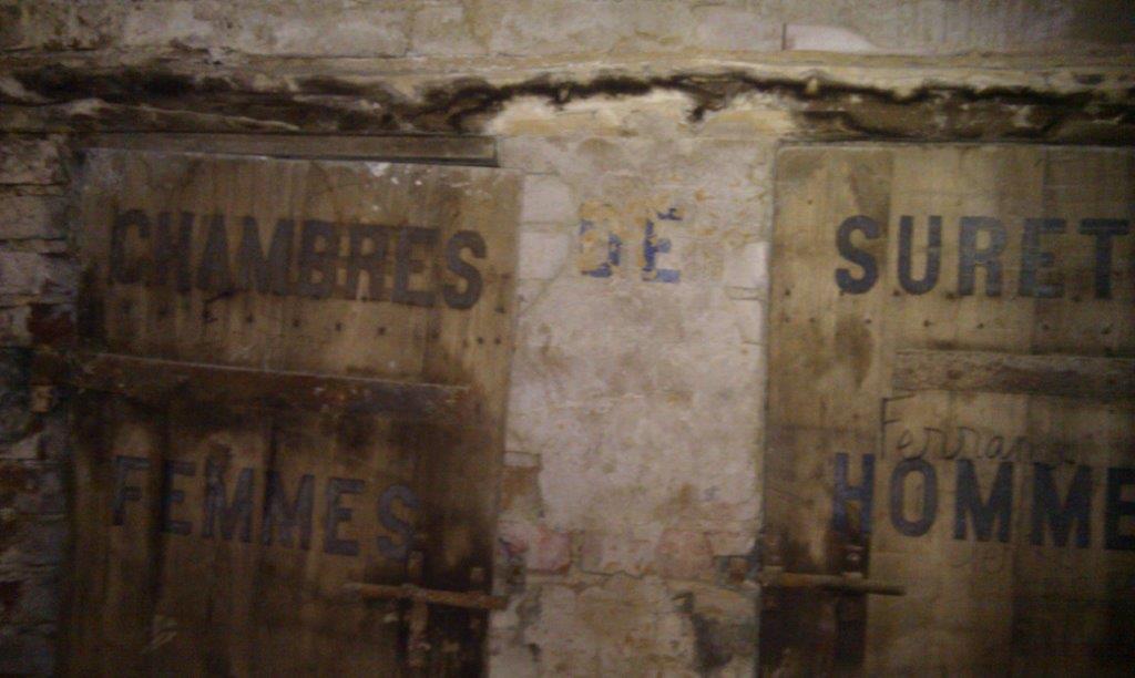 Historic signs for women's and men's chambers in an old building in Oradour Sur Vayres, Limousin, Fr.