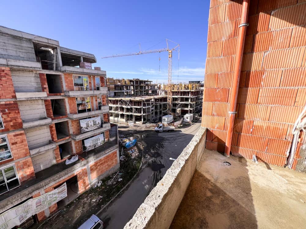 Construction site with ongoing building work for new residential apartments.