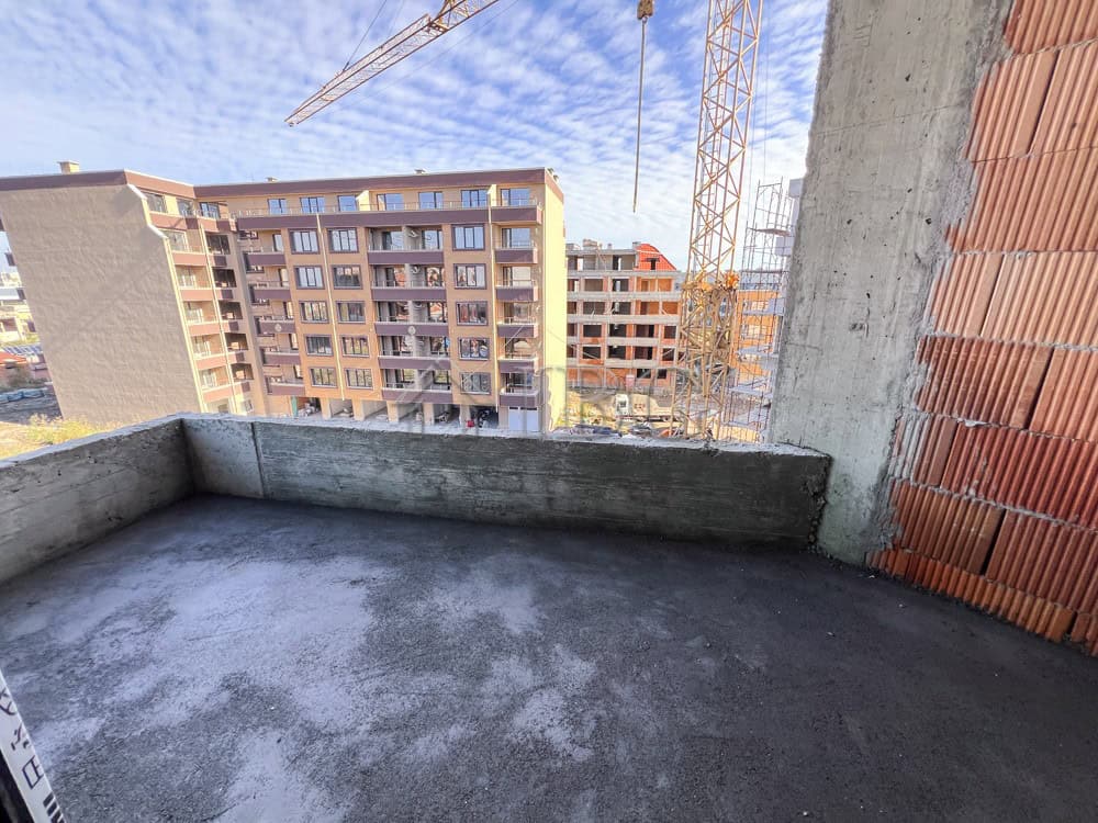 Balcony of a 1-bedroom apartment overlooking Pomorie cityscape, under construction in a new resident.