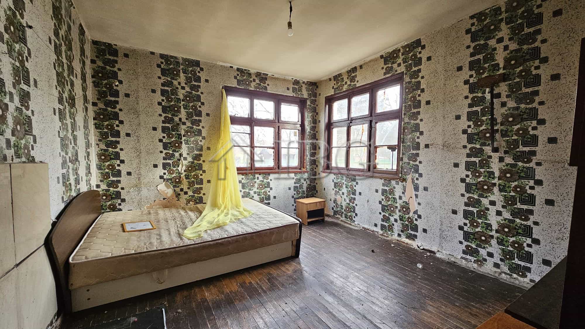 Interior of a house with large windows and a wooden floor in Gyulyovtsa Village, Burgas Region.