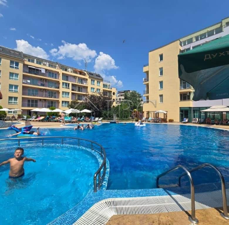 Pool view of the 2-room apartment at Pollo Resort, Sunny Beach, with relaxing swimming pool and sun.