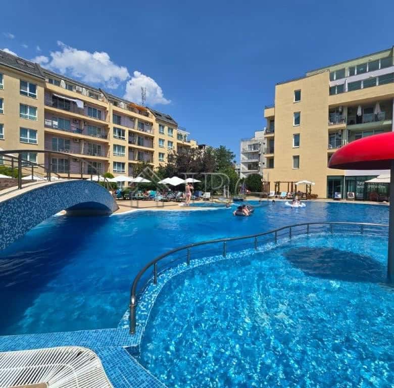 Pool view of a 2-room apartment at Pollo Resort, Sunny Beach, with a large swimming pool and surroun.